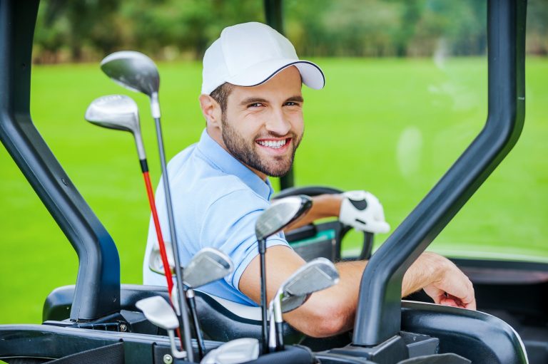 Golfer in golf cart.